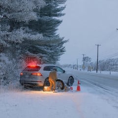 Vehicle pulled to side of rural Grey Bruce road performing a safe emergency roadside tire change in winter